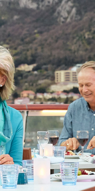 Group dining on scenic outdoor deck