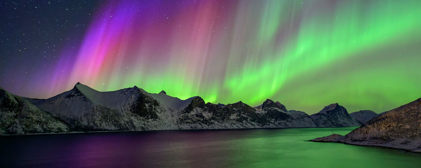 Vibrant Northern Lights Over Snowy Mountains