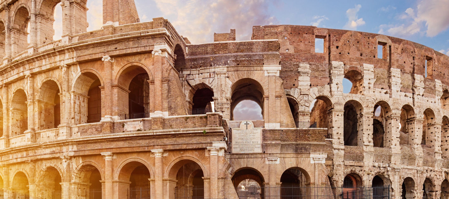 Colosseum at sunrise with vibrant sky