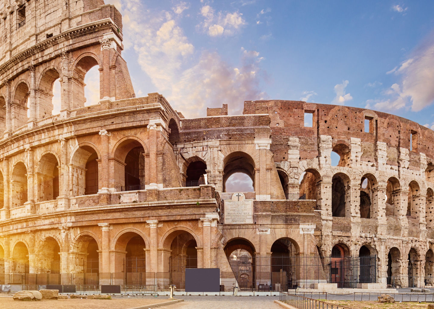 Colosseum at sunrise with vibrant sky