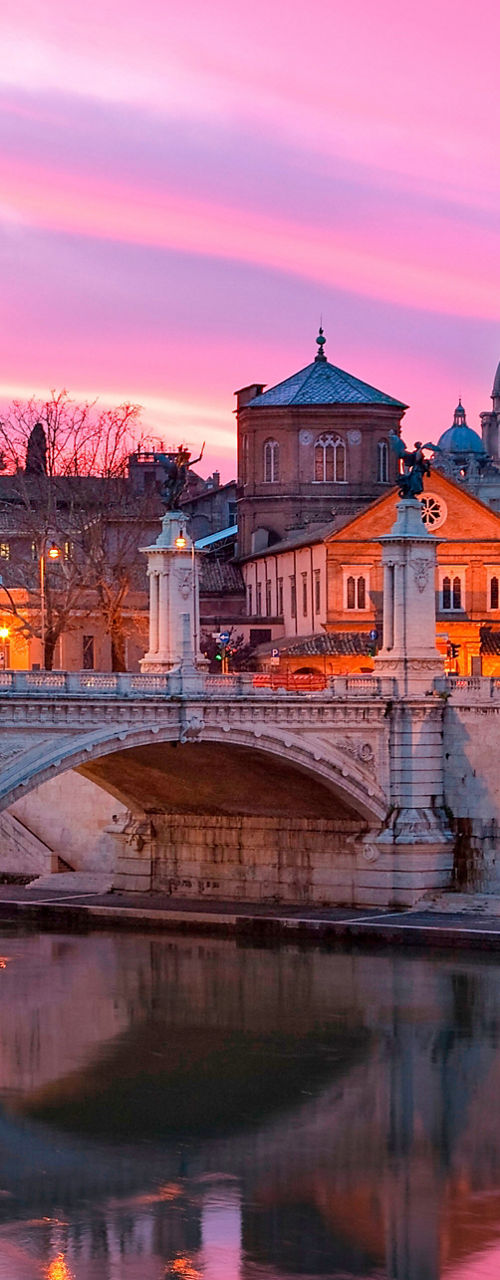 St. Peter's Basilica at sunset over river