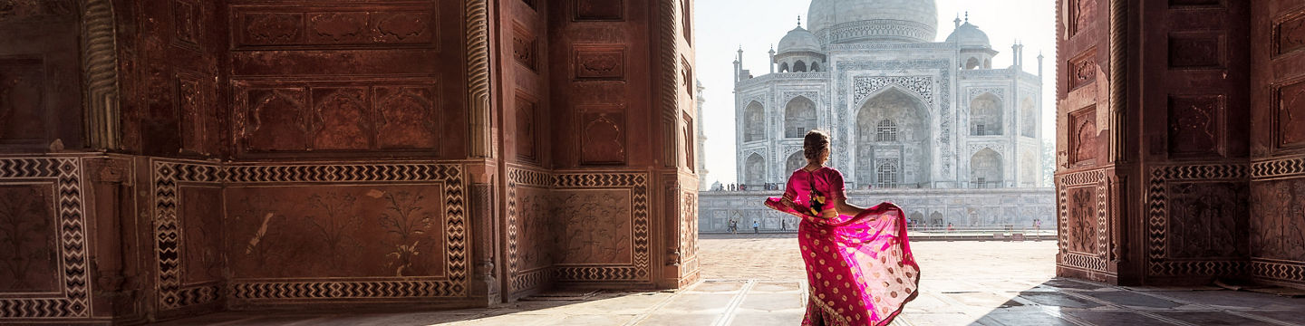 Woman in vibrant sari at Taj Mahal