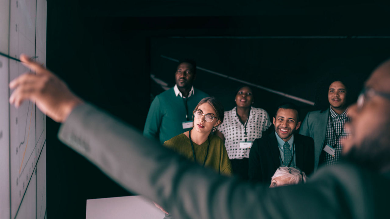 Man giving presentation to group of people.