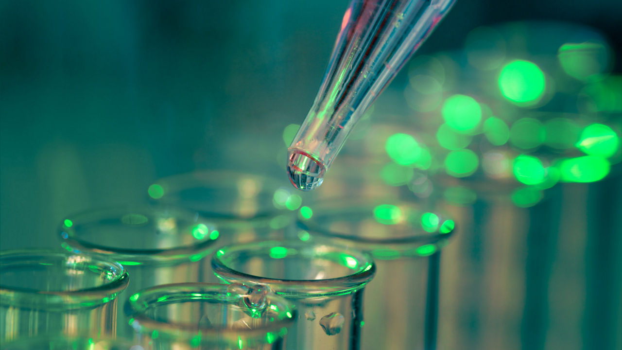 Pipette adding fluid to one of several test tubes