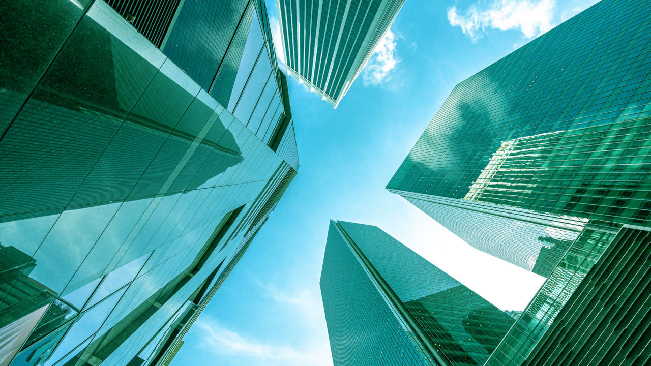 Modern office building with blue sky and clouds