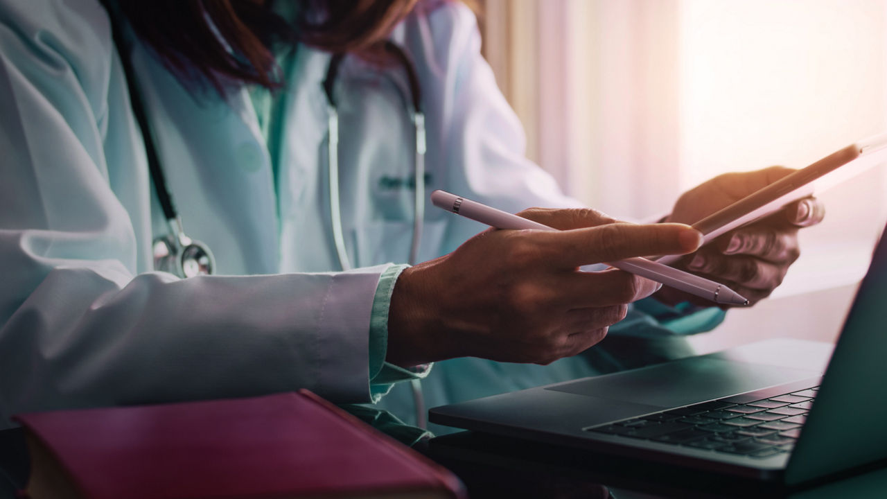 Doctor reading notes at desk