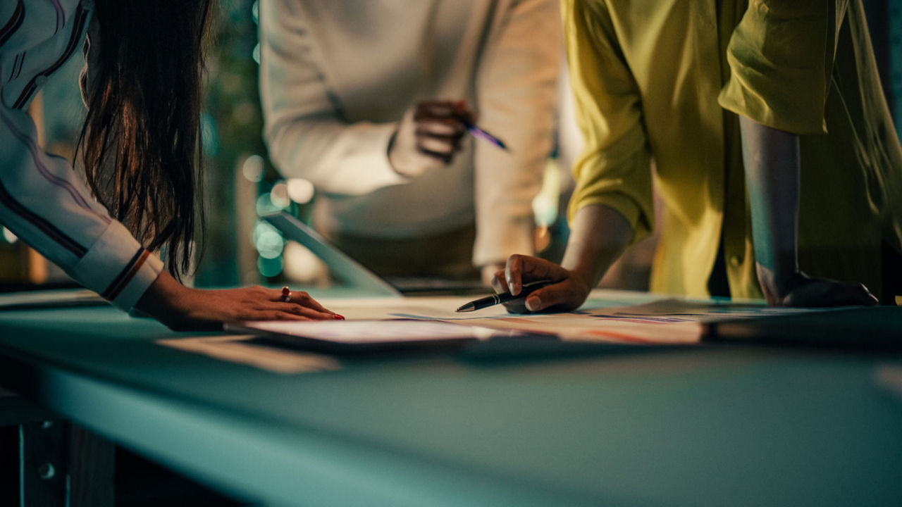 A group of professionals working together around a table in a office. 